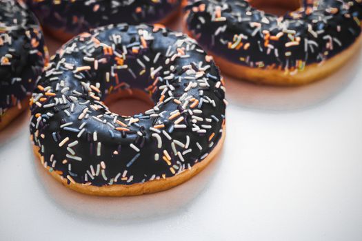 Bakery, branding and cafe concept - Frosted sprinkled donuts, sweet pastry dessert on marble table background, doughnuts as tasty snack, top view food brand flat lay for blog, menu or cookbook design