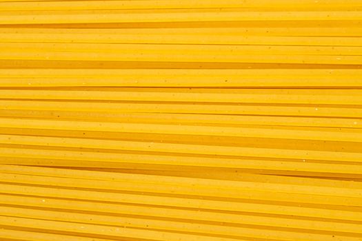 Uncooked whole grain spaghetti closeup, italian pasta as organic food ingredient, macro product and cook book recipes