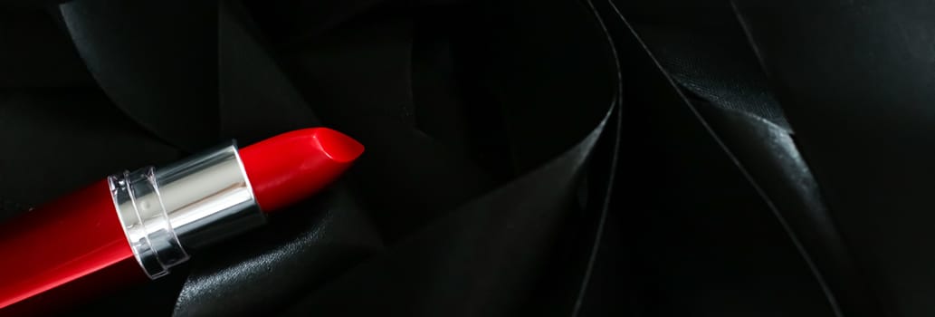 Red lipstick on black silk background, luxury make-up and beauty cosmetics