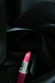 Pink lipstick on black silk background, luxury make-up and beauty cosmetics