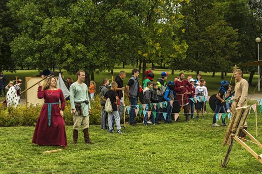 Belarus, Minsk – 03 Sep 2016: the Woman in the red dress swung his spear to throw it at the target on the pageant