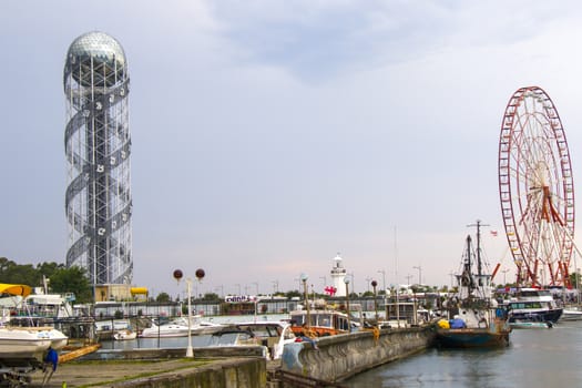 BATUMI, GEORGIA - JULY 08, 2020: Batumi harbor and port, Alphabet tower, boats and ships. City landscape of Batumi.
