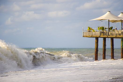 BATUMI, GEORGIA - JULY 09, 2020: Stormy weather, waves and splashes in Batumi, Georgia. Stormy Black sea. Water background.