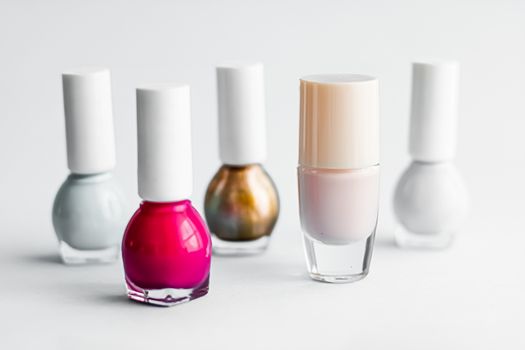 Nail polish bottles on white background, beauty branding