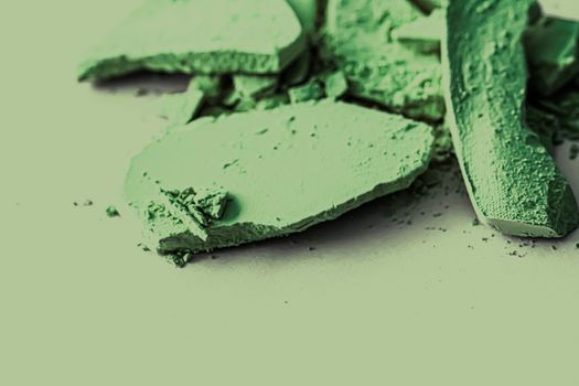 Green eye shadow powder as makeup palette closeup, crushed cosmetics and beauty textures