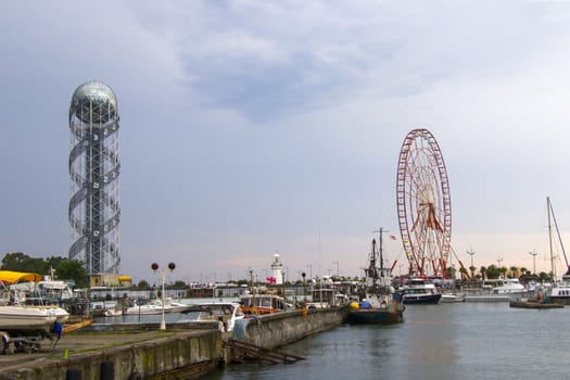 BATUMI, GEORGIA - JULY 08, 2020: Batumi harbor and port, Alphabet tower, boats and ships. City landscape of Batumi.