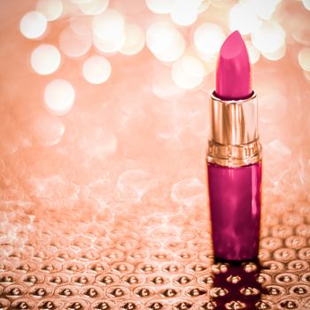 Cosmetic branding, sale and glamour concept - Pink lipstick on rose gold Christmas, New Years and Valentines Day holiday glitter background, make-up and cosmetics product for luxury beauty brand