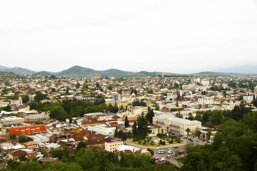 KUTAISI, GEORGIA - MAY 07, 2018: City view of old buildings and architecture, old famous city in Georgia and mountain range.