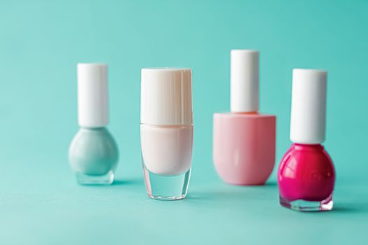 Nail polish bottles on green background, beauty branding