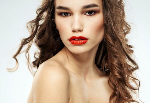 Beautiful lady red lips curly hair makeup portrait. High quality photo