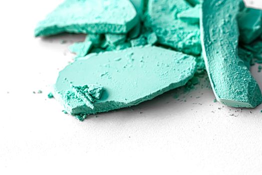 Mint eye shadow powder as makeup palette closeup isolated on white background, crushed cosmetics and beauty textures