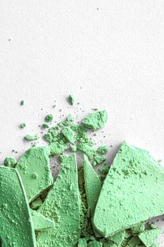 Green eye shadow powder as makeup palette closeup isolated on white background, crushed cosmetics and beauty textures