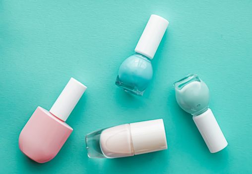 Nail polish bottles on green background, beauty branding