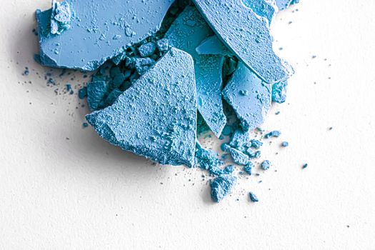 Blue eye shadow powder as makeup palette closeup isolated on white background, crushed cosmetics and beauty textures