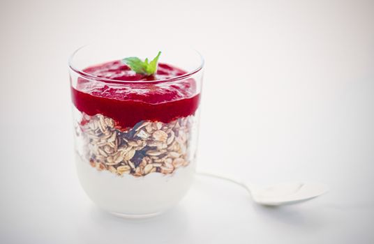 Sweet, oat and vegan concept - Homemade granola parfait with berry jam and mint, yogurt and muesli cereal as healthy breakfast food in the morning, organic dairy yoghurt for diet nutrition brand