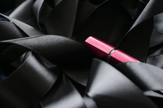 Pink lipstick on black silk background, luxury make-up and beauty cosmetics