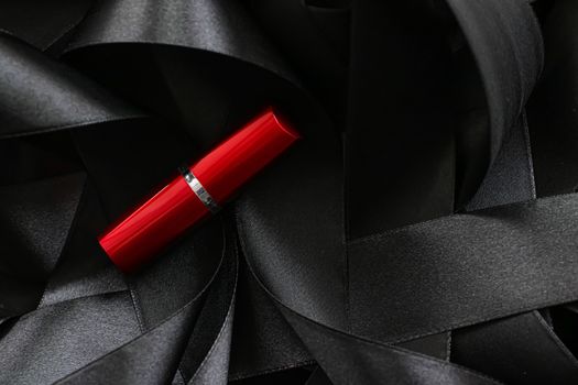 Red lipstick on black silk background, luxury make-up and beauty cosmetics