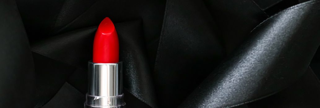 Red lipstick on black silk background, luxury make-up and beauty cosmetics