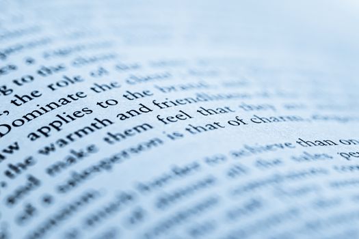 Blue toned macro closeup of an open book, education and studies