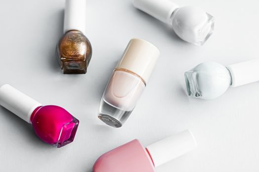 Nail polish bottles on white background, beauty branding