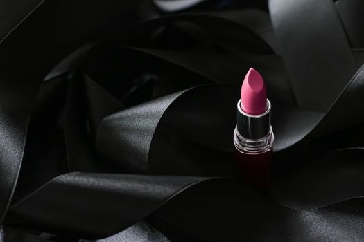 Pink lipstick on black silk background, luxury make-up and beauty cosmetics