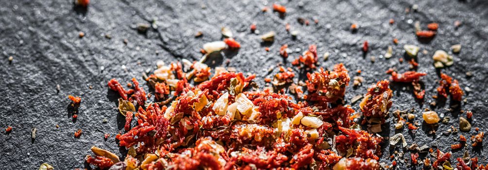 Dried tomato and chili pepper closeup on luxury stone background as flat lay, dry food spices and recipe ingredients