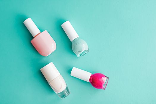 Nail polish bottles on green background, beauty branding