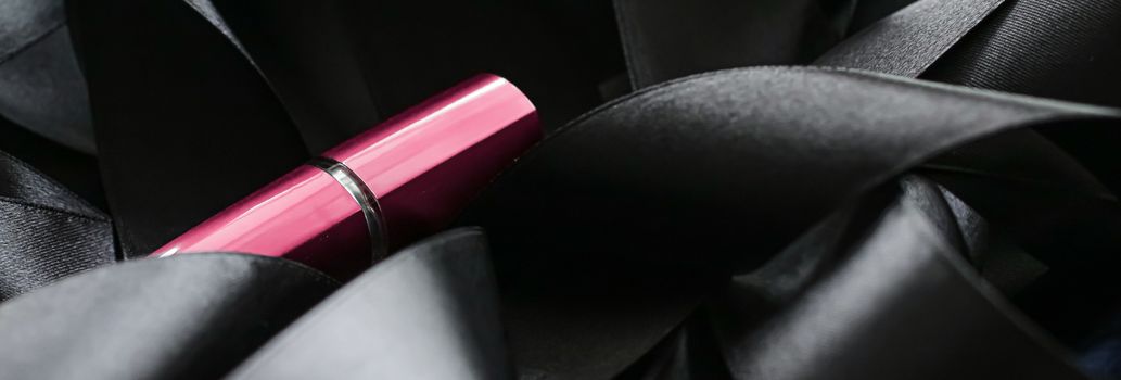 Pink lipstick on black silk background, luxury make-up and beauty cosmetics