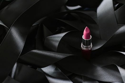 Pink lipstick on black silk background, luxury make-up and beauty cosmetics