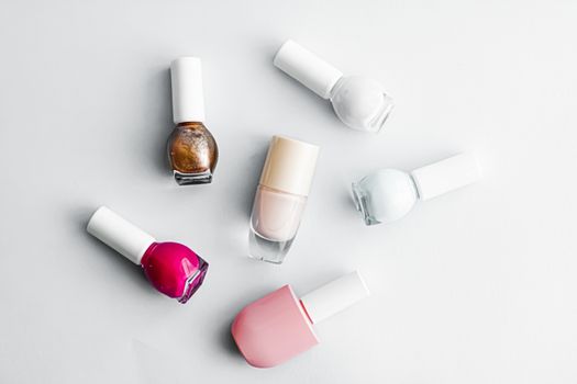 Nail polish bottles on white background, beauty branding