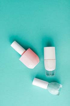 Nail polish bottles on green background, beauty branding