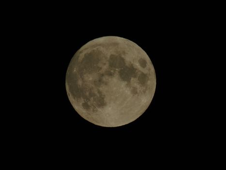 An amazing photography of the full moon over the city of Genova by night with a great clear sky in background and some stars