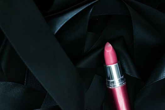 Pink lipstick on black silk background, luxury make-up and beauty cosmetics