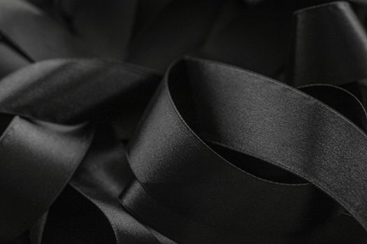 Black silk ribbon as background, abstract and luxury brand designs