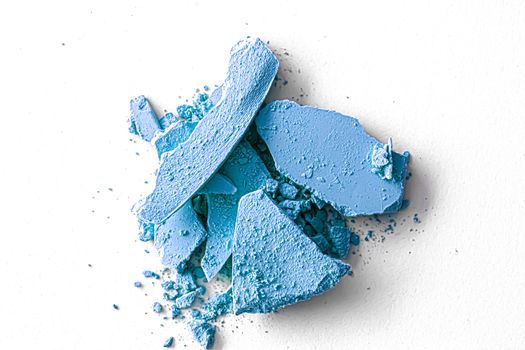 Blue eye shadow powder as makeup palette closeup isolated on white background, crushed cosmetics and beauty textures