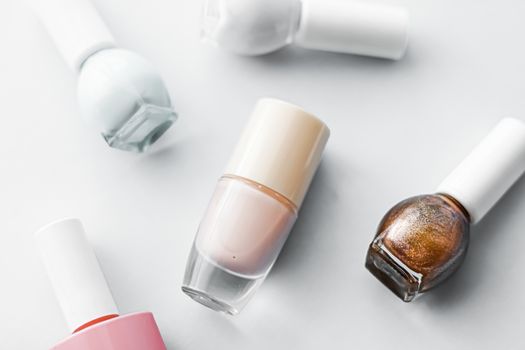 Nail polish bottles on white background, beauty branding