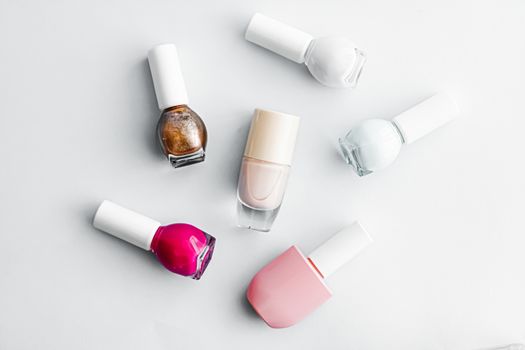 Nail polish bottles on white background, beauty branding