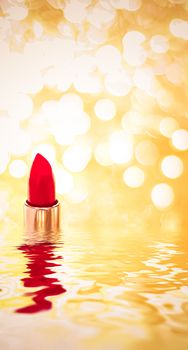 Red lipstick on golden background, make-up and cosmetics product