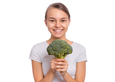 Happy beautiful young teen girl holding perfect product for dieting green broccoli, isolated on white background