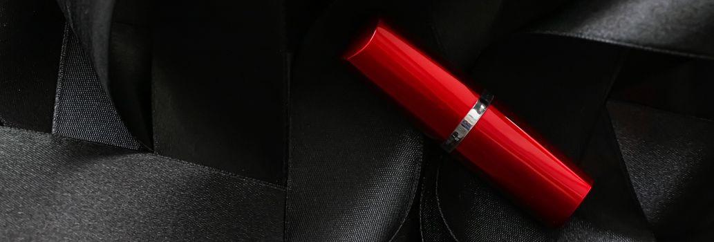 Red lipstick on black silk background, luxury make-up and beauty cosmetics