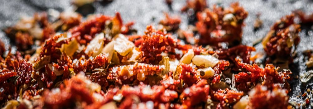 Dried tomato and chili pepper closeup on luxury stone background as flat lay, dry food spices and recipe ingredients