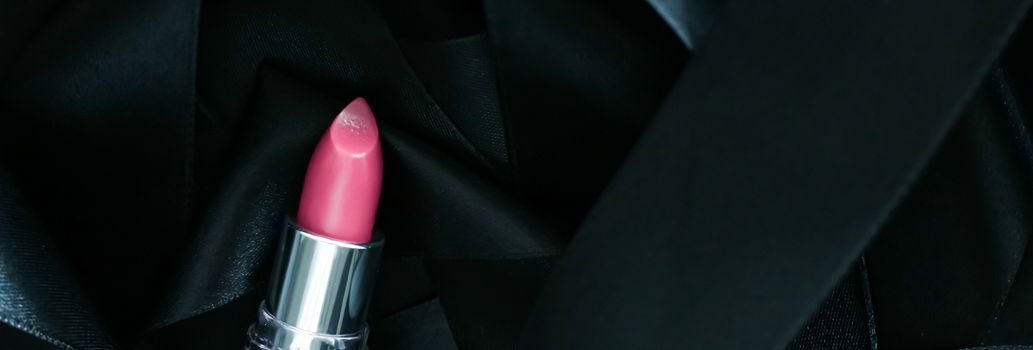 Pink lipstick on black silk background, luxury make-up and beauty cosmetics