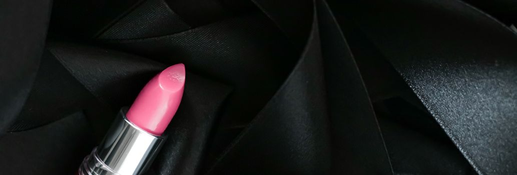 Pink lipstick on black silk background, luxury make-up and beauty cosmetics