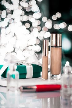 Cosmetic branding, Christmas glitter and girly blog concept - Holiday make-up foundation base, concealer and green gift box, luxury cosmetics present and blank label products for beauty brand design