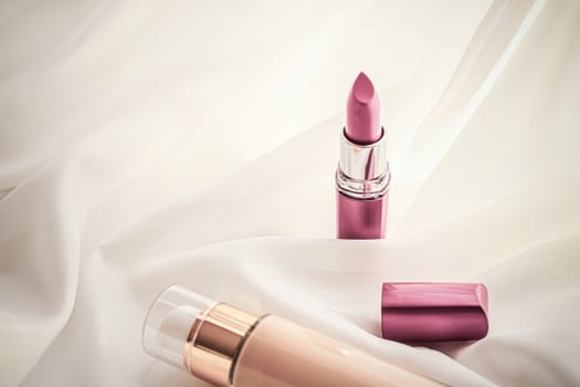 Cosmetic branding, glamour and skincare concept - Beige tonal cream bottle make-up fluid foundation base and pink lipstick on silk background, cosmetics products as luxury beauty brand holiday design