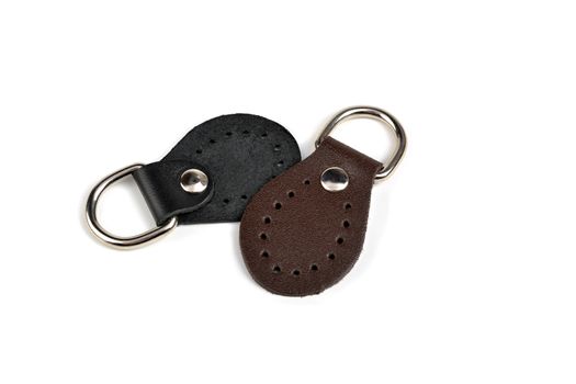 Blank black brown round color leather key chain collection on isolated white background with clipping path. Pile set of metallic souvenir.