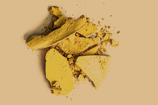Yellow eye shadow powder as makeup palette closeup, crushed cosmetics and beauty textures