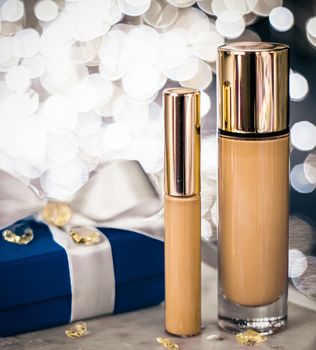 Cosmetic branding, Christmas glitter and girly blog concept - Holiday make-up foundation base, concealer and blue gift box, luxury cosmetics present and blank label products for beauty brand design