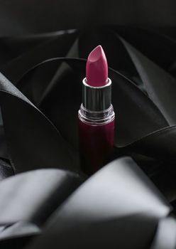 Pink lipstick on black silk background, luxury make-up and beauty cosmetics