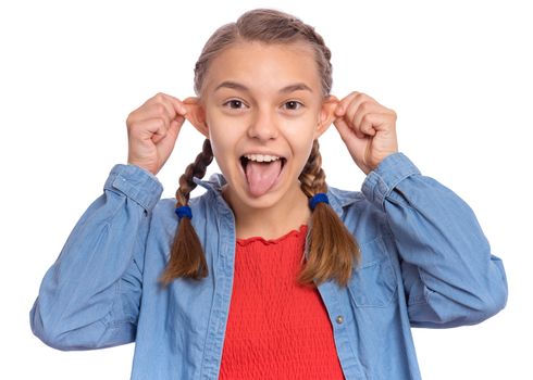 Beautiful crazy teenage girl makes funny face and sticks out tongue, plays fool, being in good mood, isolated on white background